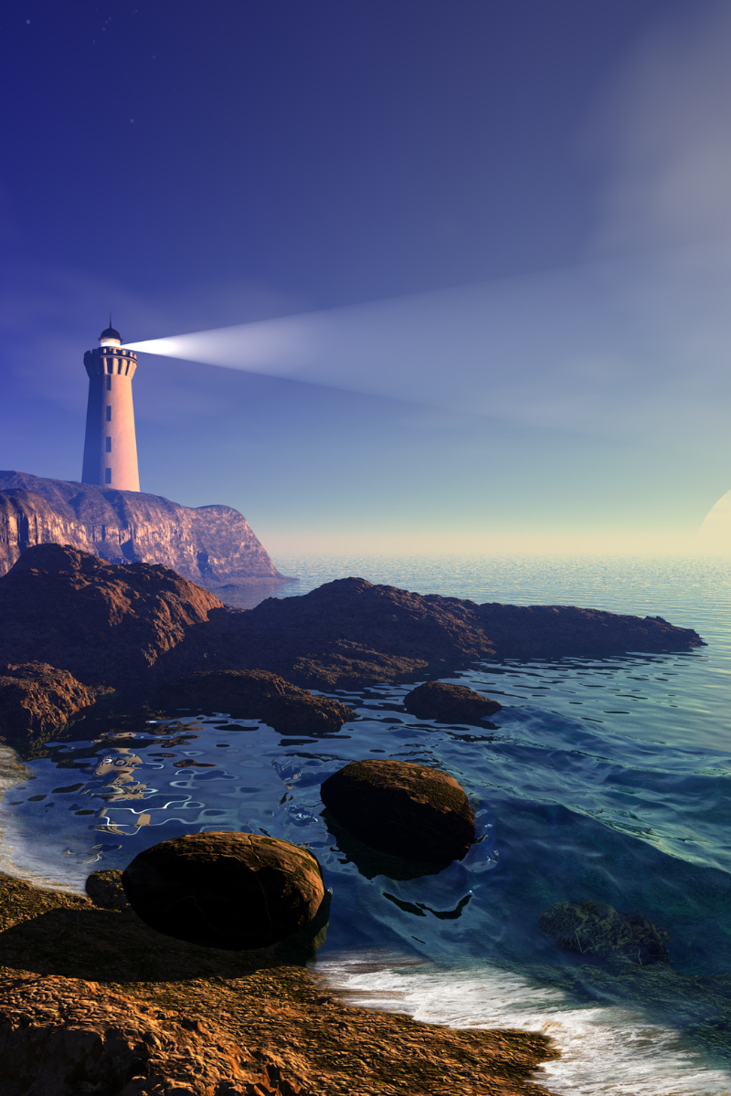 Picture of a lighthouse on a clifftop.  In the foreground there is a small area of beach visible, as well as rocks in the sea.  The lighthouse beam is visible and directed towards a rising sun